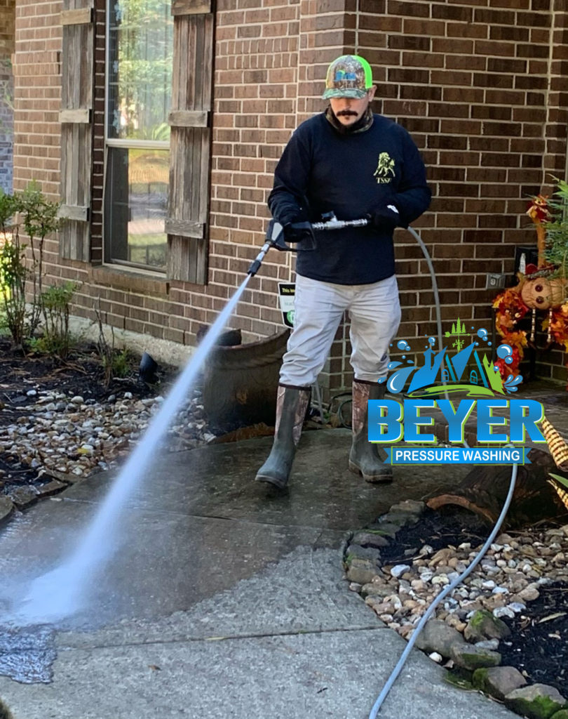 Owner, Josh Beyer, getting his feet wet as a sidewalk washing begins.