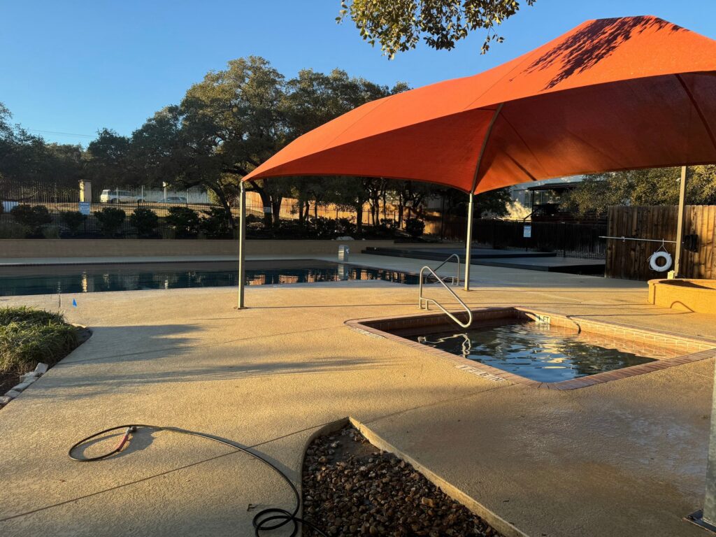 The Service Being Done Is Pressure Washing The Concrete Surfaces Around A Pool And Hot Tub Area