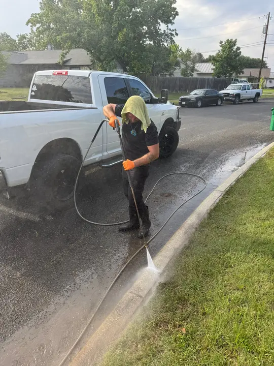 The Service Being Done Is Pressure Washing The Curb And Surrounding Pavement Surfaces To Remove Dirt And Debris