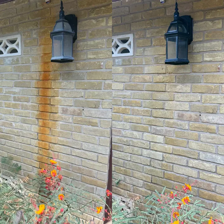 Pressure Washing Is Being Done To Remove Rust Stains From The Brick Wall Next To The Light Fixture